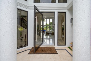 Experience breathtaking long lake views from this grand estate on St. Andrews Country Club of Boca Raton in Florida - for sale on GolfHomes.com, golf home, golf lot
