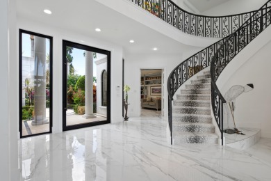 Experience breathtaking long lake views from this grand estate on St. Andrews Country Club of Boca Raton in Florida - for sale on GolfHomes.com, golf home, golf lot