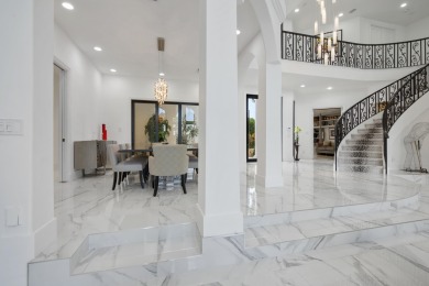 Experience breathtaking long lake views from this grand estate on St. Andrews Country Club of Boca Raton in Florida - for sale on GolfHomes.com, golf home, golf lot