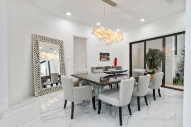 Experience breathtaking long lake views from this grand estate on St. Andrews Country Club of Boca Raton in Florida - for sale on GolfHomes.com, golf home, golf lot