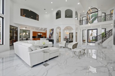 Experience breathtaking long lake views from this grand estate on St. Andrews Country Club of Boca Raton in Florida - for sale on GolfHomes.com, golf home, golf lot