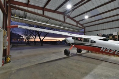 Rate takeoffs and landings from your back patio!  This lovely on Pecan Plantation Country Club in Texas - for sale on GolfHomes.com, golf home, golf lot