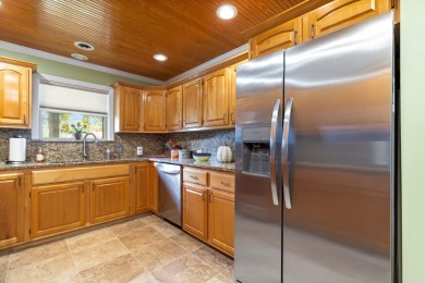 Surrounded by mature trees on a peaceful lot, this home blends on The Coves Golf Course in Oklahoma - for sale on GolfHomes.com, golf home, golf lot