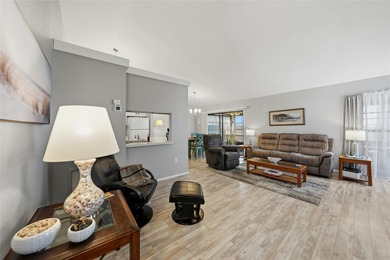 Step into this bright end unit condo with sweeping lake views on Sabal Trace Golf and Country Club in Florida - for sale on GolfHomes.com, golf home, golf lot