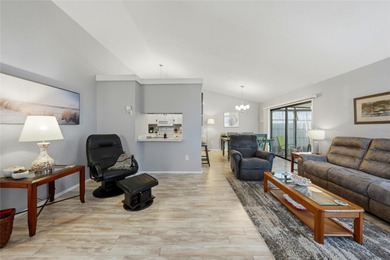 Step into this bright end unit condo with sweeping lake views on Sabal Trace Golf and Country Club in Florida - for sale on GolfHomes.com, golf home, golf lot