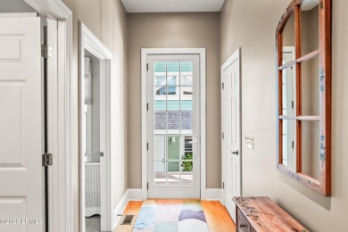 Unwind on your screened porch with front-row views of Davis on Ocean Creek Golf Course in South Carolina - for sale on GolfHomes.com, golf home, golf lot