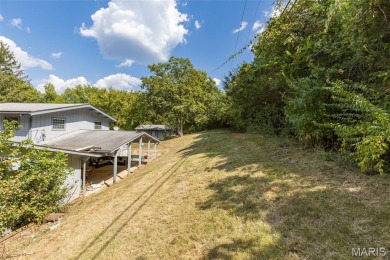 Unique and full of charm, this home sits on four lots totaling 2 on Terre Du Lac Golf and Country Club in Missouri - for sale on GolfHomes.com, golf home, golf lot