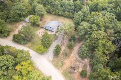 Unique and full of charm, this home sits on four lots totaling 2 on Terre Du Lac Golf and Country Club in Missouri - for sale on GolfHomes.com, golf home, golf lot