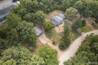 Unique and full of charm, this home sits on four lots totaling 2 on Terre Du Lac Golf and Country Club in Missouri - for sale on GolfHomes.com, golf home, golf lot