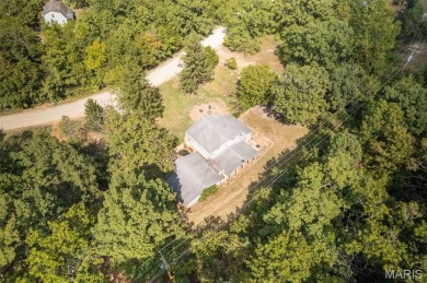 Unique and full of charm, this home sits on four lots totaling 2 on Terre Du Lac Golf and Country Club in Missouri - for sale on GolfHomes.com, golf home, golf lot