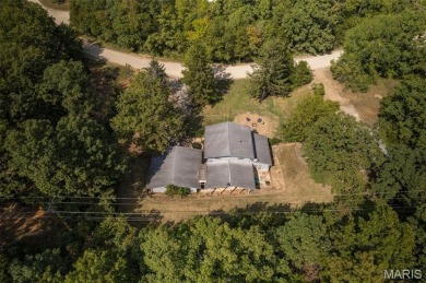 Unique and full of charm, this home sits on four lots totaling 2 on Terre Du Lac Golf and Country Club in Missouri - for sale on GolfHomes.com, golf home, golf lot