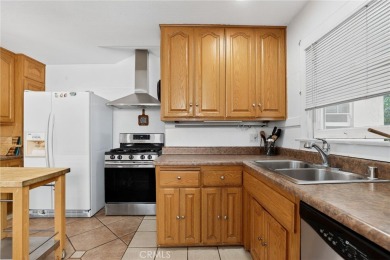 Discover this Spanish-style fixer located on a desirable corner on Mile Square Golf Course in California - for sale on GolfHomes.com, golf home, golf lot