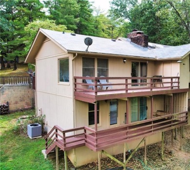 Discover the charm of Bella Vista living in this inviting on Bella Vista Country Club and Golf Course in Arkansas - for sale on GolfHomes.com, golf home, golf lot