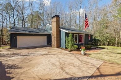 This lovely home is snuggled amongst the trees in the gated & on Carolina Trace Country Club in North Carolina - for sale on GolfHomes.com, golf home, golf lot