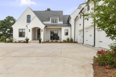 Experience resort-style living in this exceptional residence on Reunion Golf Club in Mississippi - for sale on GolfHomes.com, golf home, golf lot