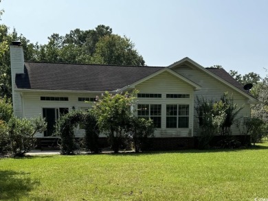 This two-bedroom three bath home is tucked away on a quiet on Wedgefield Plantation Golf Club in South Carolina - for sale on GolfHomes.com, golf home, golf lot