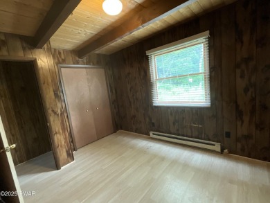 Fall in love with this sweet, simple, and affordable getaway in on The Hideout Golf in Pennsylvania - for sale on GolfHomes.com, golf home, golf lot