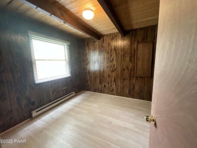 Fall in love with this sweet, simple, and affordable getaway in on The Hideout Golf in Pennsylvania - for sale on GolfHomes.com, golf home, golf lot