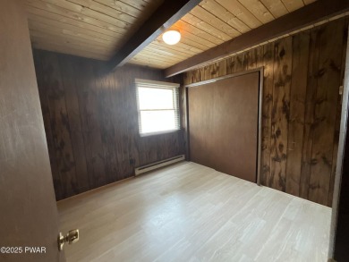 Fall in love with this sweet, simple, and affordable getaway in on The Hideout Golf in Pennsylvania - for sale on GolfHomes.com, golf home, golf lot