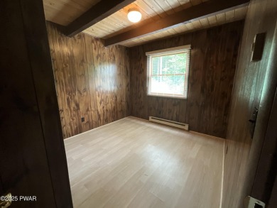 Fall in love with this sweet, simple, and affordable getaway in on The Hideout Golf in Pennsylvania - for sale on GolfHomes.com, golf home, golf lot