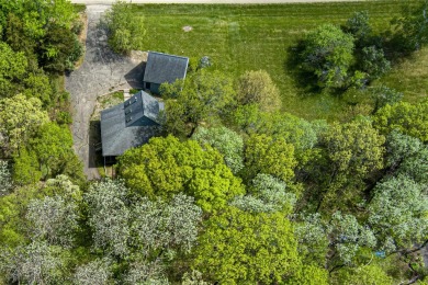 This Branigar farmhouse-style home is set on a beautiful, wooded on Eagle Ridge Inn and Resort in Illinois - for sale on GolfHomes.com, golf home, golf lot