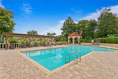 Experience serene pond views from this first-floor, corner unit on Feather Sound Country Club in Florida - for sale on GolfHomes.com, golf home, golf lot