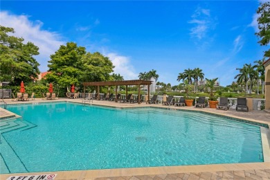 Experience serene pond views from this first-floor, corner unit on Feather Sound Country Club in Florida - for sale on GolfHomes.com, golf home, golf lot