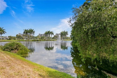 Experience serene pond views from this first-floor, corner unit on Feather Sound Country Club in Florida - for sale on GolfHomes.com, golf home, golf lot