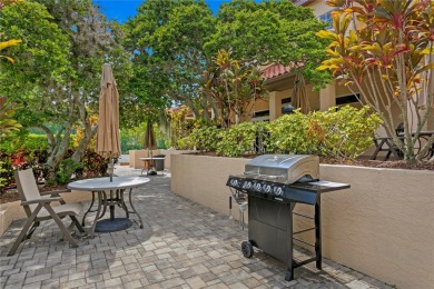 Experience serene pond views from this first-floor, corner unit on Feather Sound Country Club in Florida - for sale on GolfHomes.com, golf home, golf lot