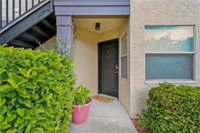 Experience serene pond views from this first-floor, corner unit on Feather Sound Country Club in Florida - for sale on GolfHomes.com, golf home, golf lot