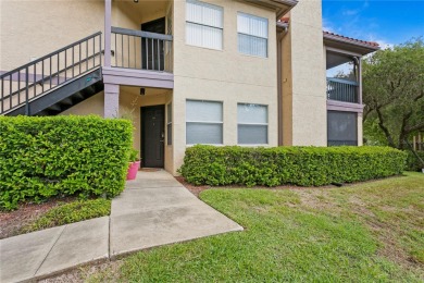 Experience serene pond views from this first-floor, corner unit on Feather Sound Country Club in Florida - for sale on GolfHomes.com, golf home, golf lot