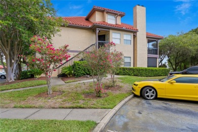 Experience serene pond views from this first-floor, corner unit on Feather Sound Country Club in Florida - for sale on GolfHomes.com, golf home, golf lot