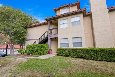 Experience serene pond views from this first-floor, corner unit on Feather Sound Country Club in Florida - for sale on GolfHomes.com, golf home, golf lot