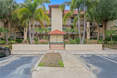 Experience serene pond views from this first-floor, corner unit on Feather Sound Country Club in Florida - for sale on GolfHomes.com, golf home, golf lot