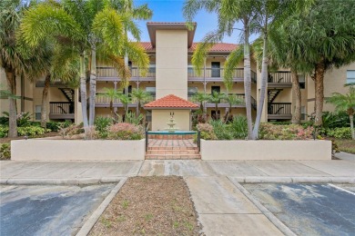 Experience serene pond views from this first-floor, corner unit on Feather Sound Country Club in Florida - for sale on GolfHomes.com, golf home, golf lot