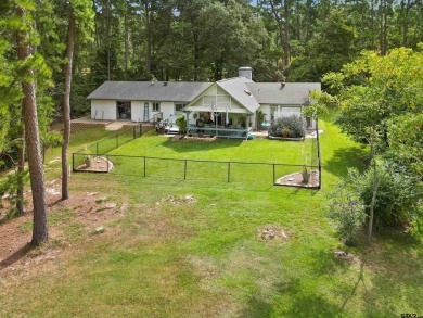 This spacious home sitting on the 16th fairway in Holly Lake on Holly Lake Ranch Golf Club in Texas - for sale on GolfHomes.com, golf home, golf lot