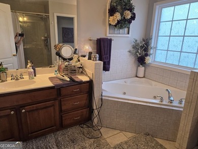 Welcome to this beautifully maintained all-brick home, ideally on Canongate At Georgia National Golf Club in Georgia - for sale on GolfHomes.com, golf home, golf lot