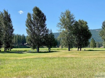 Great 1 acre lot on the18 hole Meadows Golf Course in Seeley on Double Arrow Lodge in Montana - for sale on GolfHomes.com, golf home, golf lot