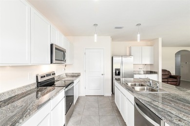 Light flows gracefully through every room of this elegant on Lake Diamond Golf and Country Club in Florida - for sale on GolfHomes.com, golf home, golf lot