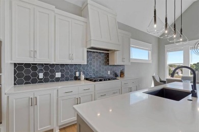 This 4-bedroom, 4-bath reverse 1.5-story is packed with upgrades on Heritage Park Golf Course in Kansas - for sale on GolfHomes.com, golf home, golf lot