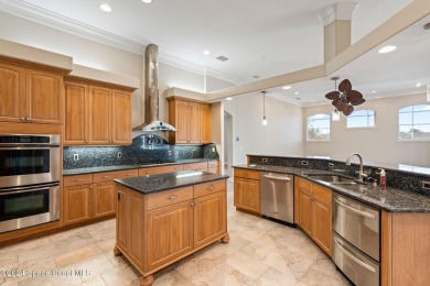 This stunning executive home exudes modern elegance and boasts on Baytree National Golf Links in Florida - for sale on GolfHomes.com, golf home, golf lot