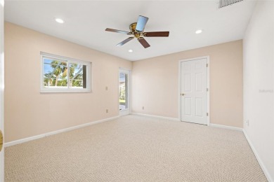 This spacious 4-bedroom, 3-bath POOL home is located in the on Mangrove Bay Golf Course in Florida - for sale on GolfHomes.com, golf home, golf lot