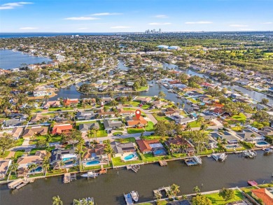 This spacious 4-bedroom, 3-bath POOL home is located in the on Mangrove Bay Golf Course in Florida - for sale on GolfHomes.com, golf home, golf lot