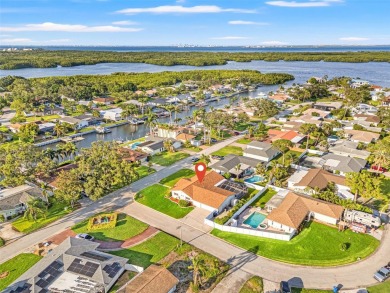 This spacious 4-bedroom, 3-bath POOL home is located in the on Mangrove Bay Golf Course in Florida - for sale on GolfHomes.com, golf home, golf lot