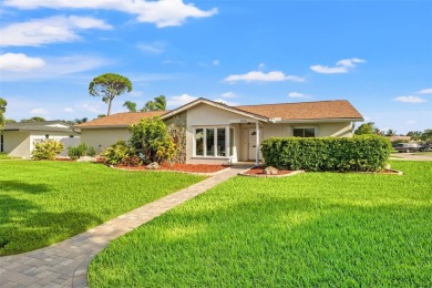 This spacious 4-bedroom, 3-bath POOL home is located in the on Mangrove Bay Golf Course in Florida - for sale on GolfHomes.com, golf home, golf lot