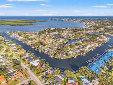 This spacious 4-bedroom, 3-bath POOL home is located in the on Mangrove Bay Golf Course in Florida - for sale on GolfHomes.com, golf home, golf lot