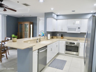 Bright open plan corner unit has TWO balconies overlooking woods on Harbour Village Golf and Yacht Club in Florida - for sale on GolfHomes.com, golf home, golf lot