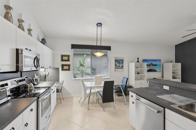 Spacious, meticulously maintained home in a gated community with on Woodmont Country Club in Florida - for sale on GolfHomes.com, golf home, golf lot