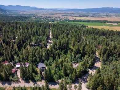 Tucked into the trees on a quiet street in Star Valley Ranch on Star Valley RV Golf Course in Wyoming - for sale on GolfHomes.com, golf home, golf lot