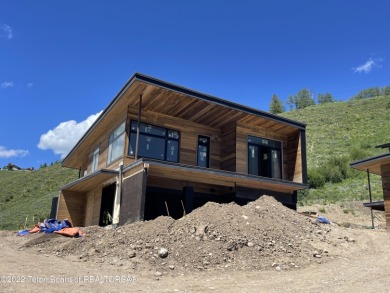 UNDER CONSTRUCTION: This modern mountain home is elevated to on Snake River Sporting Club in Wyoming - for sale on GolfHomes.com, golf home, golf lot